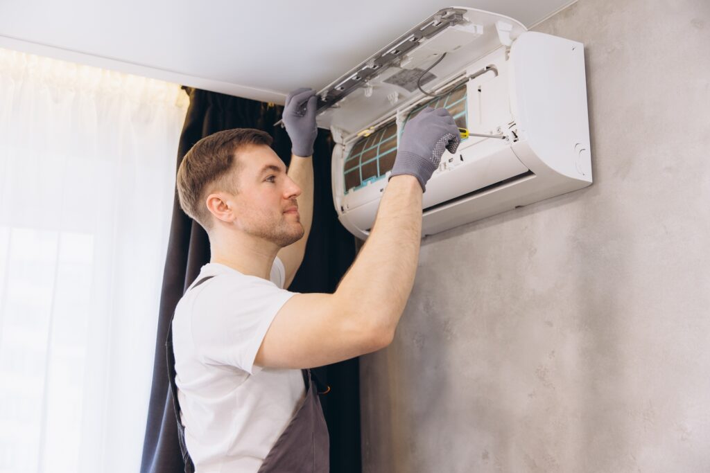 Repairing Air Conditioner Unit with Screwdriver